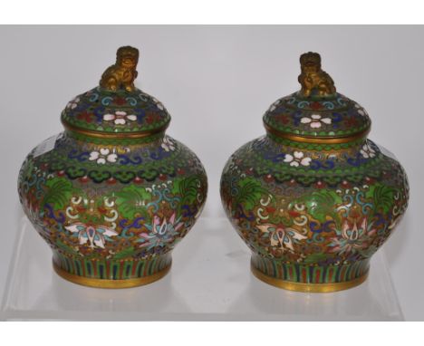 Pair Chinese cloisonne lidded bowls blossom decorated on green ground, temple dog finial to lids. (Height 11cm approx, each).
