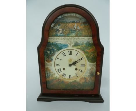 A mantle clock depicting scenes of the countryside including fox, pheasants, ducks and deer, roman numerals with key, height 