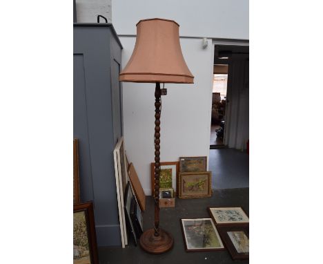An oak standing lamp with turned base and pink shade 190cmH