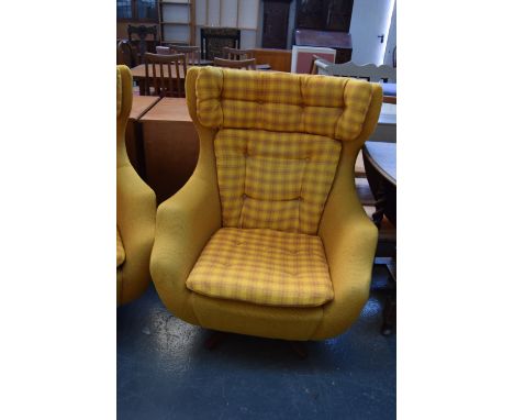 A Parker Knoll swivel armchair upholstered in mustard yellow and tartan button back fabric