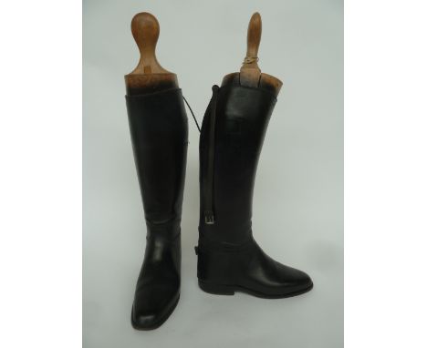 A pair of black ladies hunting boots with garter straps, size 5.5 to 6, with wooden trees
