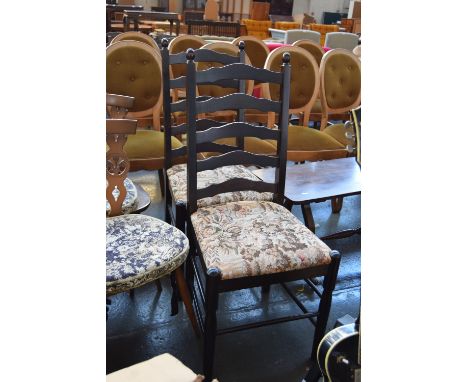 Two ladder back dining chairs with floral upholstered seats on turned legs