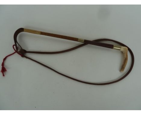 A child's hunting whip with two metal collars and 4ft leather thong