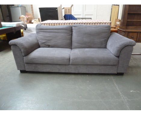 A large modern grey upholstered three seater sofa