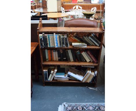 An oak bookcase with four shelves, the side panels with carved tops and incised diamond design, each shelf with studding to t