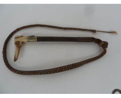 An interesting hare coursing whip,probably Victorian, with plaited shaft and metal collar depicting a running stag with carve