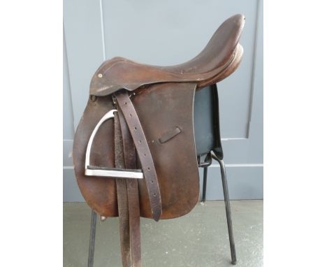 A Coleman Croft child's hunting saddle with stirrup leathers and irons 16in together with one other