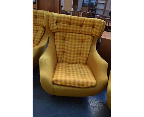 A Parker Knoll swivel armchair upholstered in mustard yellow and tartan button back fabric