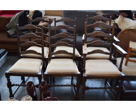 A set of six ladder back dining chairs including two carvers, cream upholstered seats on turned legs