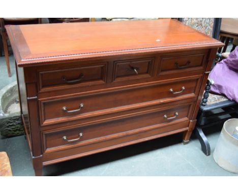 A 19th century style commode with three short drawers, central with lock and key, over two long drawers with brass handles 12