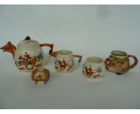 A Bovey Pottery "Resting Fox" jug together with a set of Portland Pottery Company china, with fox hunting scenes. All stamped