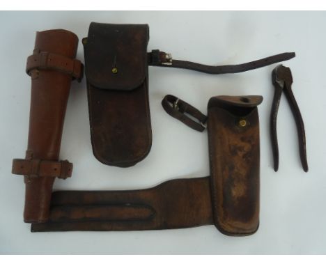 A leather hunting horn case; two leather wire cutter cases, one containg wire cutter (4)