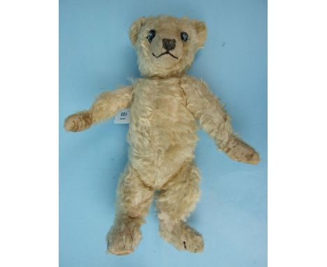 A Chiltern "Hugmee" blonde mohair teddy bear with stitched eyes, vertically stitched nose and claws and velveteen pads, 37cm.