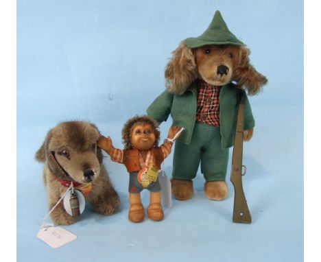 Steiff, three animals: a "Macki" hedgehog, "Bazi", a Dachshund, both with cloth and paper labels and a huntsman dog with gun,