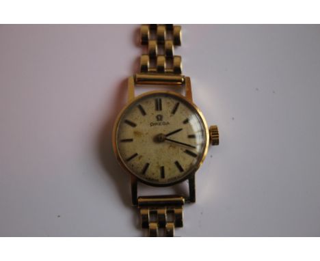 A LADIES OMEGA MANUAL WIND WRIST WATCH on an unbranded 9 ct gold strap, dedication inscription to the back