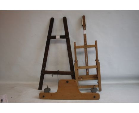 A SMALL ADJUSTABLE WOODEN ARTIST'S EASEL, H 85 cm, together with another slightly larger easel and a film winder  (3)