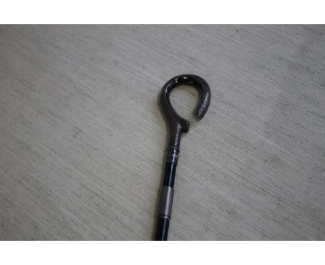 A SILVER HANDLED WALKING STICK CANE WITH LOOP STYLE HANDLE, with foliage decoration hallmarked London 1856