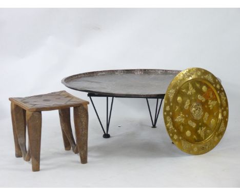 An Indian copper coffee table, a brass smaller top, and an African stool