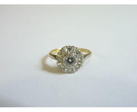 A diamond cluster ring, marked 18 platinum, finger size O