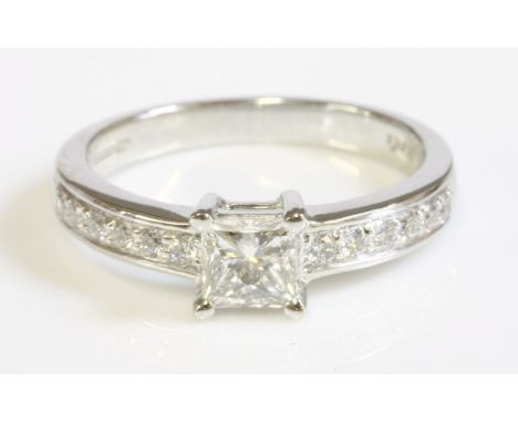 An 18ct white gold single stone diamond ring with diamond set shoulders, a princess cut diamond, 0.54ct, four claw set at the