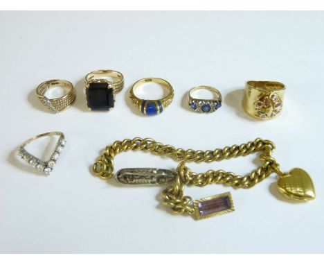 A 9ct gold smokey quartz ring, a 9ct gold twisted wire band ring, a gold cubic zirconia wishbone ring, a synthetic sapphire E