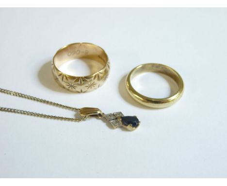 A gold sapphire and diamond pendant, on a base metal chain, a plain gold wedding ring marked 585, and a 9ct gold diamond cut 