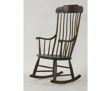 A stick back rocking chair, with curved arms