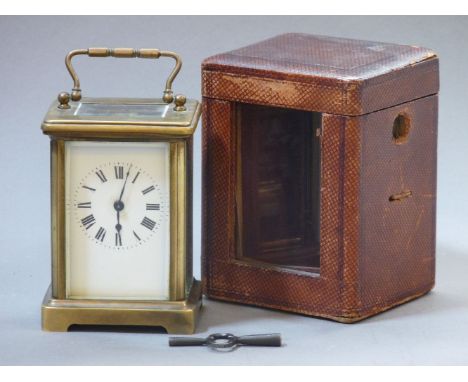 A French brass carriage clock, in red leather travelling case, 18cm to top and of handle
