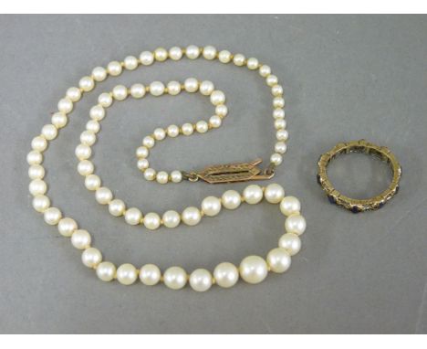 A single row graduated cultured pearl necklace, marked 9ct, and a sapphire band ring