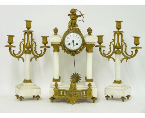 A white mantel and gilt spelter clock garniture, 50cm high
