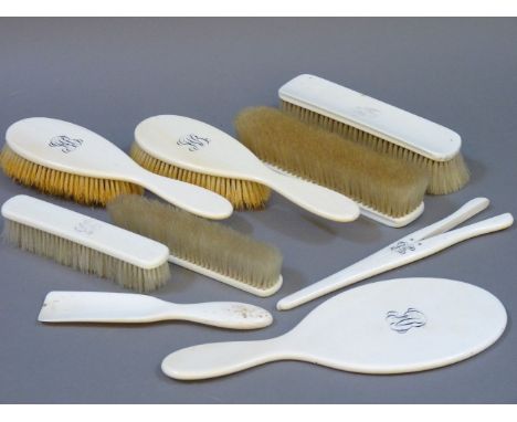 A late 19th /early 20th century ladies ivory dressing set, with four brushes, a mirror and glove stretchers, two further ivor