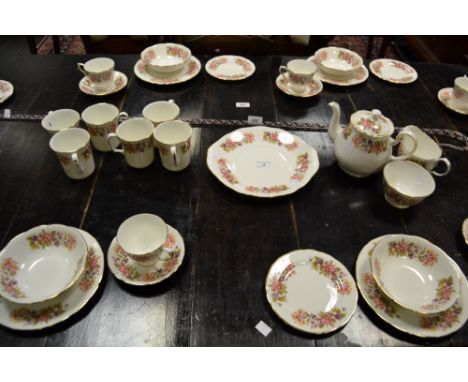 A Colclough part tea service decorated with honeysuckle and wild roses
