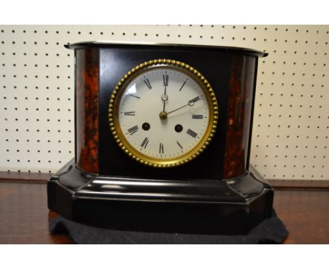 A Victorian black marble mantel clock, with enamelled dial , black Roman numerals, flanked by rouge marble quadrant stiles