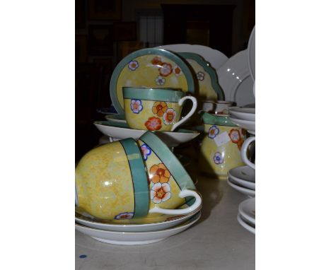 A Noritake tea service, for six, printed with flowers on a yellow lustre ground, banded in green, printed marks