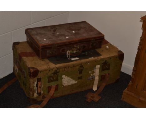 A large travelling trunk with leather straps and handles, a 20th century leather suitcase 