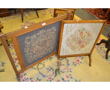 An early 20th century oak fire screen, the panel with scrolling leaf in shades of red and green; another smaller