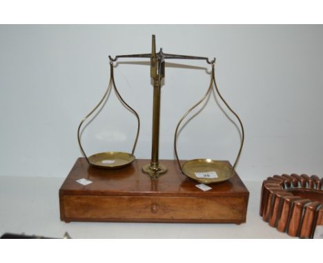 A late 19th / early twentieth century pharmacists  scales , one horizontal drawer , with weights 