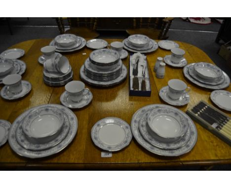 A Noritake Blue Hill pattern part dinner service, decorated in bands of cobalt blue flowers; cased flatware
