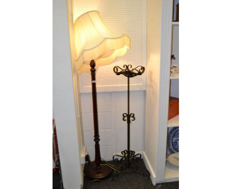  A wrought iron  stand; a standard lamp.