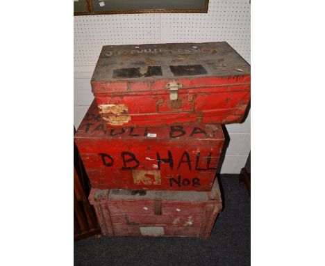 An early 20th century wooden trunk, painted red; a 20th Century metal trunk, another (3)