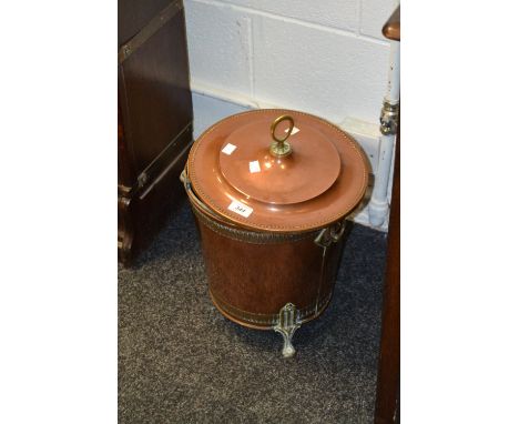 A copper coal scuttle and lid, with brass ring handles, spelter lining