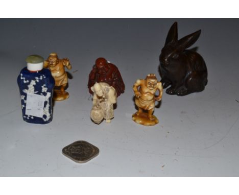 A Chinese bronzed model of a rabbit; an ivorine Japanese netsuke of an elder carrying a pot; a pair of resin models of mythic