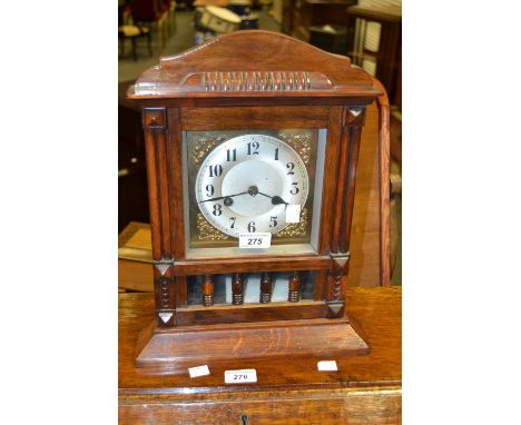 A 1930s oak mantel clock, moulded cornice
