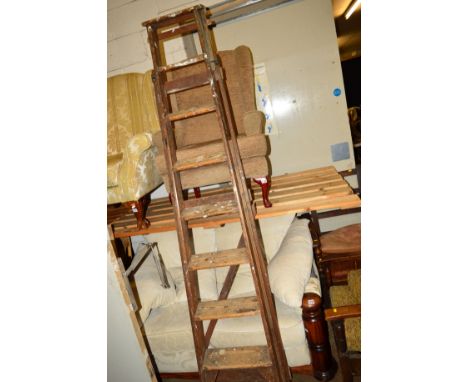A TALL WOODEN STEP LADDER