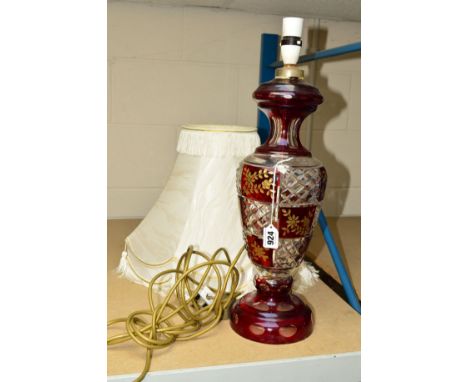 A LARGE RUBY FLASHED GLASS TABLE LAMP, with a cream shade, height 42cm (not including fitting)