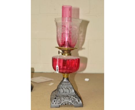 AN OIL LAMP, with ruby coloured funnel and well and similar glass shade, height 47cm