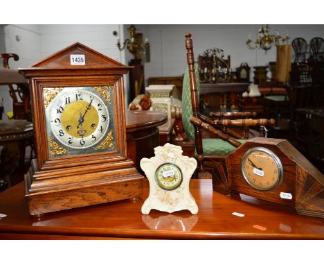 AN EARLY 20TH CENTURY OAK BRACKET CLOCK, with silvered Arabic numerals, together with an oak mantel clock and a ceramic clock