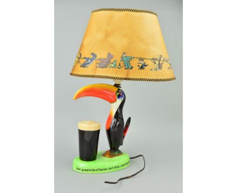 A CARLTONWARE GUINNESS ADVERTISING TABLE LAMP AND SHADE, depicting Toucan and glass of Guinness, approximate height 24cm (not