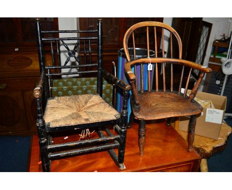 A GEORGIAN ELM STICK BACK CHILDS WINDSOR ARMCHAIR together with an Edwardian rush seated childs rocking chair (2)