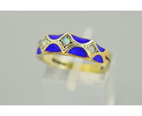 A 9CT GOLD ENAMEL AND OPAL RING, designed as scalloped blue guilloche enamel panels centrally set with three circular opals (